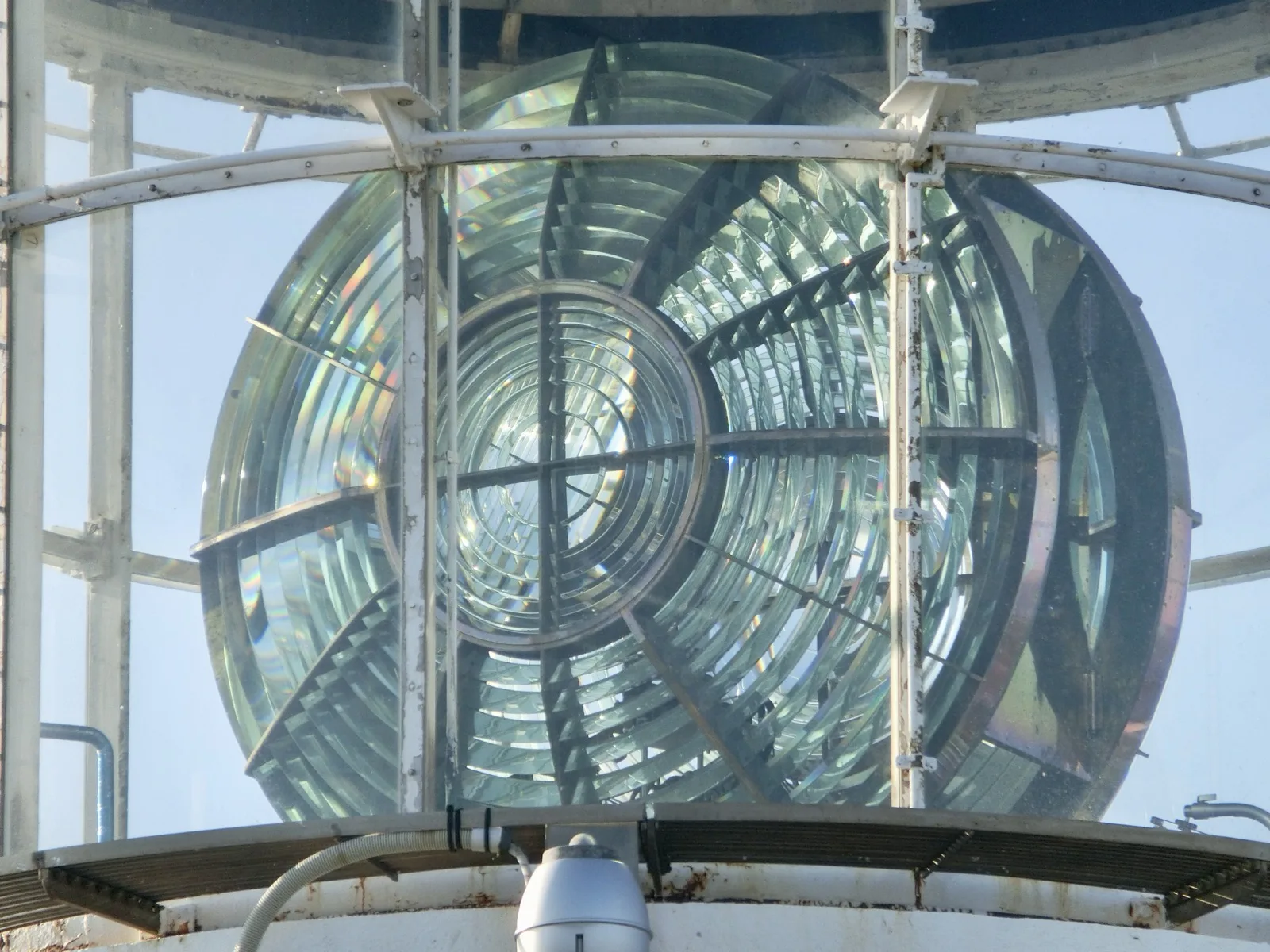 The third-order large Fresnel lens at Cape Erimo Lighthouse: a large lens of concentric prism rings mounted inside a white-framed lantern room